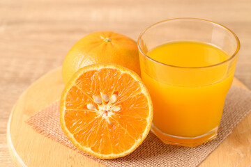 Fresh Honey Murcott orange fruit and juice on wooden background, Healthy drink