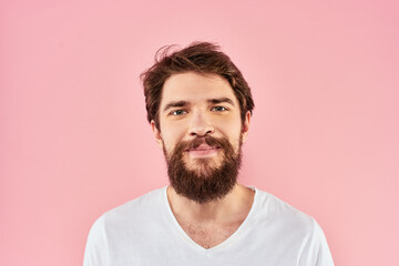 Obraz premium Man in white t-shirt gestures with hands emotions lifestyle cropped view pink background