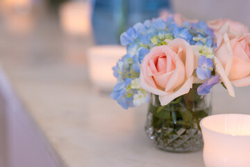 Blurred roses or flower in vase pastel with candle light, Love wedding or marriage background