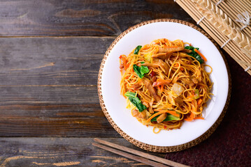 Asian food, vegetarian stir fried noodles with mushroom and vegetables, Top view