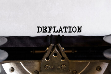 Vintage typewriter with printed text -DEFLATION, on a sheet of paper