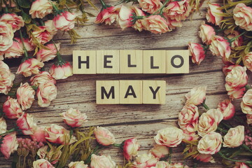 Hello April alphabet letters with flower decoration on wooden background