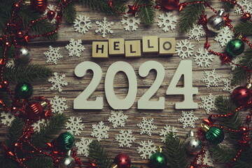Hello 2024 alphabet letters with Christmas decoration on wooden background