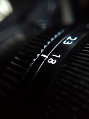 Extreme close up shot of camera lens focal distance numbers dial.