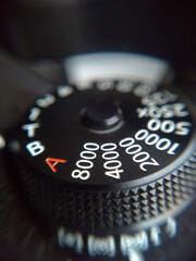 Extreme close up shot of camera mechanical ISO dial. Camera manual settings concept.