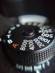 Extreme close up shot of camera mechanical ISO dial. Camera manual settings concept.