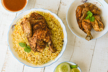 Arabic chicken Manthi or mandi cooked meat, Basmati rice with Masala, spice. Kuzhimanthi or hot and spicy Manthi on black background in Malabar Kerala, South India. Top view of Indian non veg food.