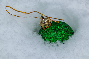beautiful Christmas fur-tree toys in the snow with the structure in the Christmas and New year