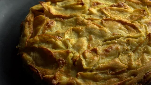Homemade cakes Apple pie with baked goods on the dark rusty wooden kitchen table red and green apples with cinnamon. Traditional American dessert. Flatley food background. The view from the top