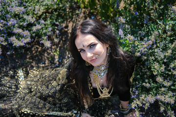 Woman in ethnic indian costume with gold jewellery and traditional makeup.