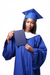 African-American beautiful woman in a blue robe and hat, on a white isolated background holding a diploma of higher education in her hands