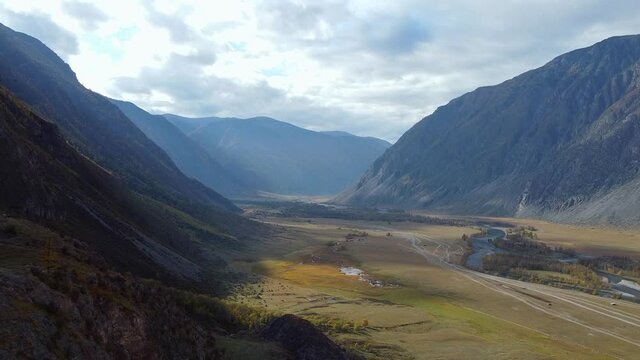 Flight over the mountains. Top view hills and river. High quality FullHD footage