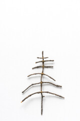 Christmas tree handmade from branches on a white background, copy space