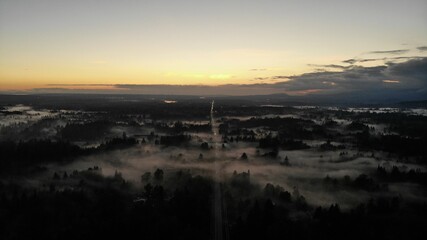 Fototapeta na wymiar sunset over rural area with fog on the ground