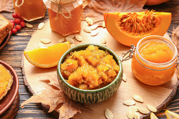 Tasty pumpkin jam on wooden background
