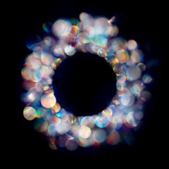 Multiple neon colored iridescent bokeh spots in round frame