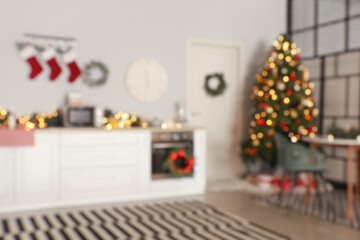 Interior of modern kitchen decorated for Christmas, blurred view