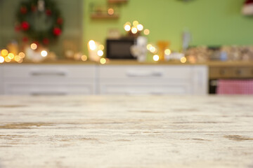 Empty wooden table in kitchen decorated for Christmas