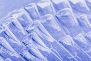 Obraz premium Glass medical ampoule vial for injection. Medicine is liquid sodium chloride with of aqueous solution in ampulla. Close up. Bottles ampule multicolor on background color and water. Human plasma.