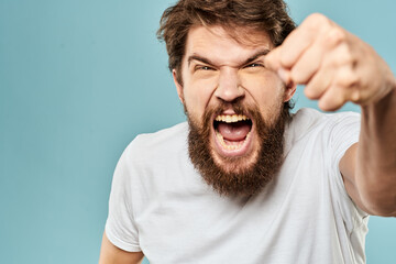 Obraz premium Bearded man emotions facial expression gestures hands close-up blue background