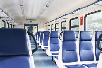 empty electric train car with blue seats during the pandemic