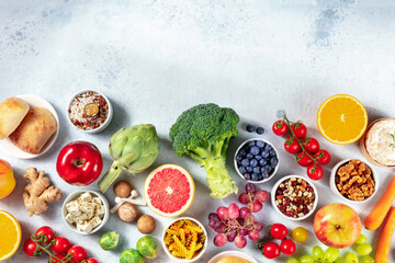 Vegetarian food products variety, overhead shot with copy space. Fruit, vegetables, cheese, mushrooms, nuts, legumes, a flat lay. The concept of a healthy diet