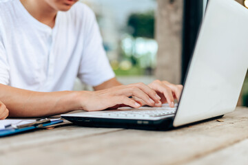 Fototapeta premium High school or college students group catching up workbook and learning tutoring on desk and reading, doing homework, lesson practice preparing exam.