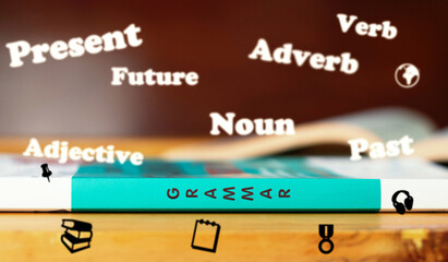 Grammar word on spine of book with floating English words above