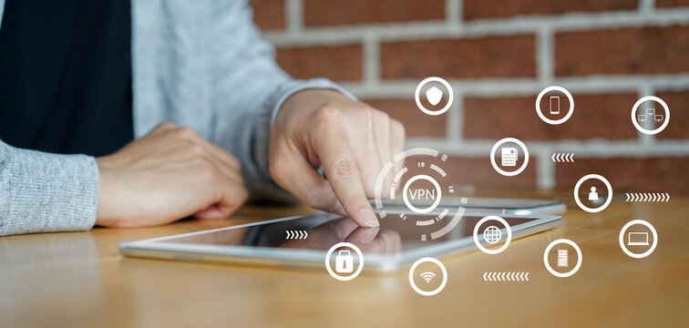 close up on man hand touch screen on digital tablet display to access VPN mode during use internet data telecommunication with interface icon for future network communication technology concept