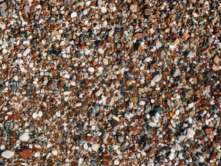 Wet sea pebbles or rocks, stones as nature background. Beautiful sea stones of different sizes, colors and texture. Excellent natural concept for interior exterior decoration or any design.