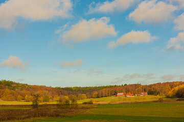 Fototapeta premium Autumn landscape with fields and a farm.