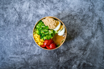 Healthy Organic Athlete Protein Food Bowl with Broccoli, Tricolor Quinoa, Peanut Butter Soy Sauce, Brown Rice, Egg and Hummus for Fitness Sport.