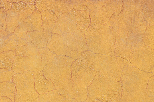 Texture detail of squiggle lines and cracks on yellow concrete,background