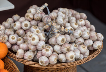 A close up view of strings of garlic in wicker basket