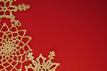 Gold crocheted snowflakes on a red background