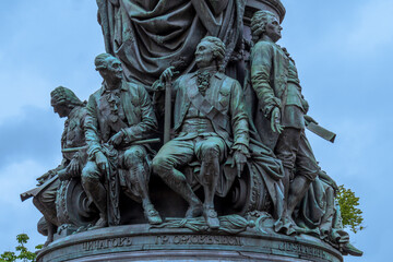 Fototapeta na wymiar Detail of the base of Statue of Catherine the Great depicting eight prominent people of the era in St. Petersburg, Russia. Architecture and history.