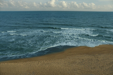 Sea with waves on beautiful sandy beach
