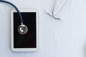 Fototapeta na wymiar computer tablet with stethoscope for tele medicine business on white background