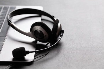 Office desk with headset and laptop