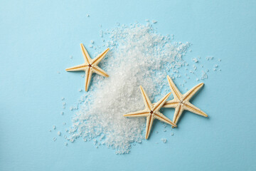 Stack of salt and sea stars on blue background