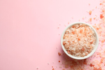 Bowl of pink himalayan salt on pink background
