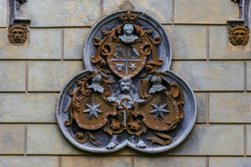 A wall sculpture illustrating shields and worrier helmet, Sturdza castle, Miclauseni, Romania