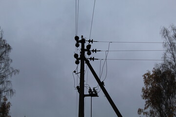 power line pillar, utility network pillars on a gray sky background