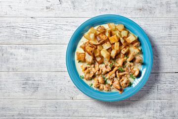 fried potato with chanterelle sauce on a plate