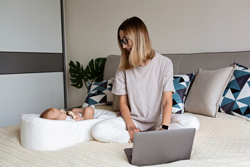 Telecommuting in quarantine. Mother showing baby to friends at the video chat. Stylish young...