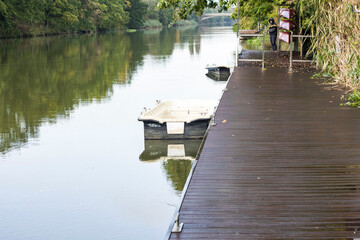 Fototapeta na wymiar River, boat, wooden pier