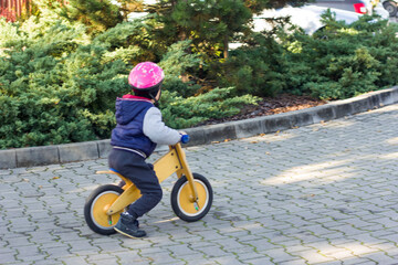 Child on a wooden Bicycle