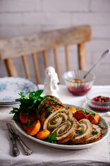 Turkey porchetta with caramelised clementines on the Christmas background .style rustic.