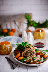 Turkey porchetta with caramelised clementines on the Christmas background .style rustic.