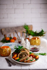 Turkey porchetta with caramelised clementines on the Christmas background .style rustic.